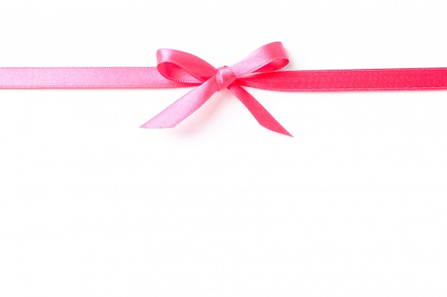 Photo pink ribbon with bow isolated on white