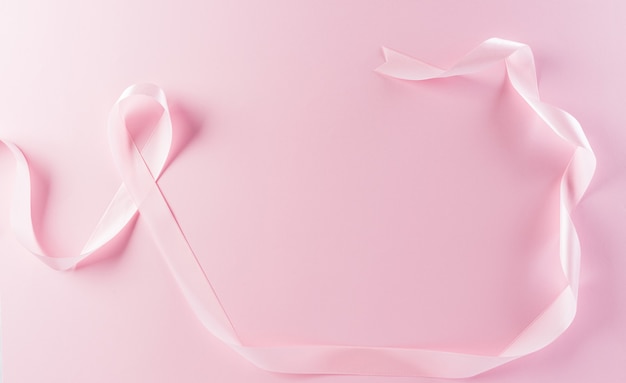 Pink ribbons on pastel background Symbol of womens breast cancer awareness