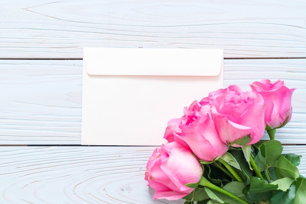 pink rose in vase on wood background