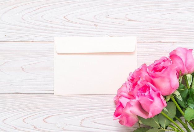 pink rose in vase on wood background