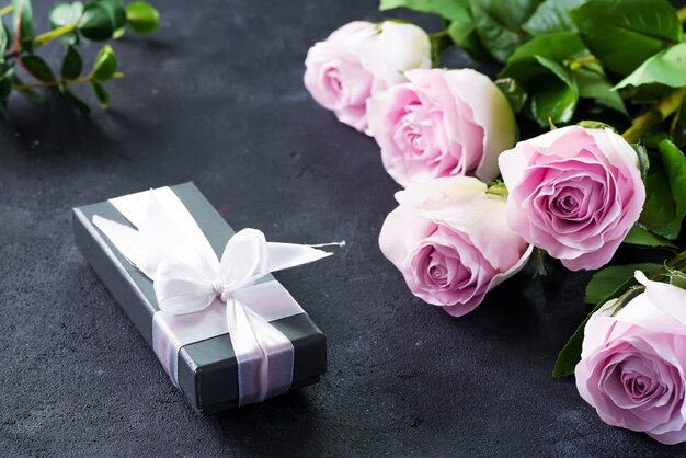 Pink roses and a gift box