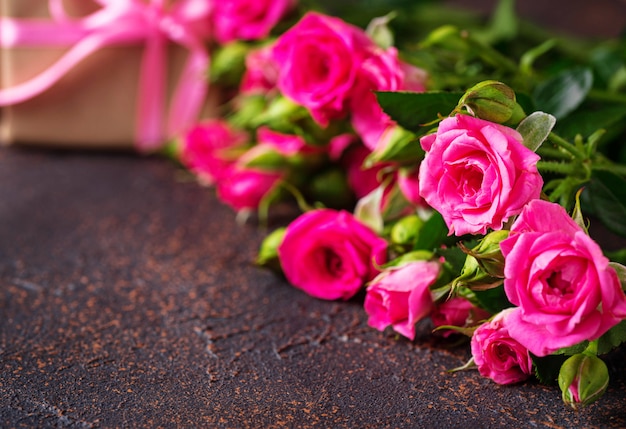 Pink roses and gift boxes with ribbons