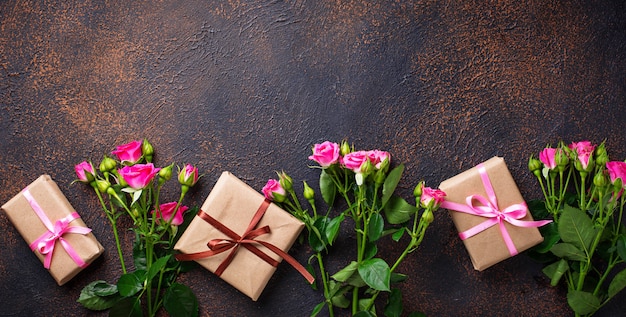 Pink roses and gift boxes with ribbons