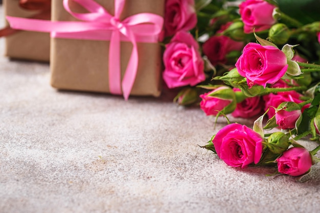 Pink roses and gift boxes with ribbons