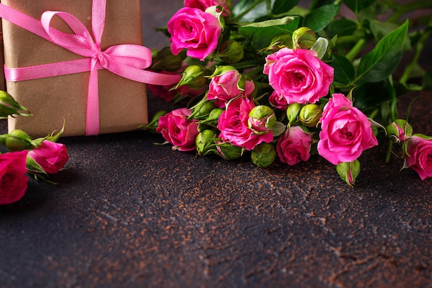 Pink roses and gift boxes with ribbons