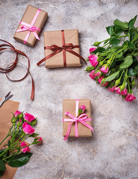 Pink roses and gift boxes with ribbons