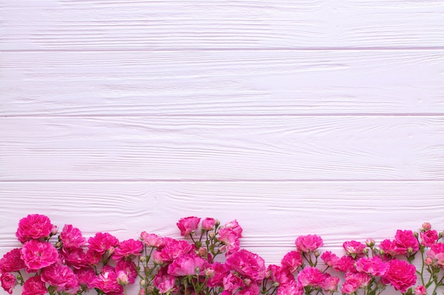 Pink roses on pink wooden table