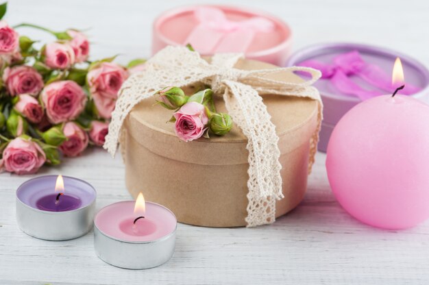 Pink roses with gift and candles