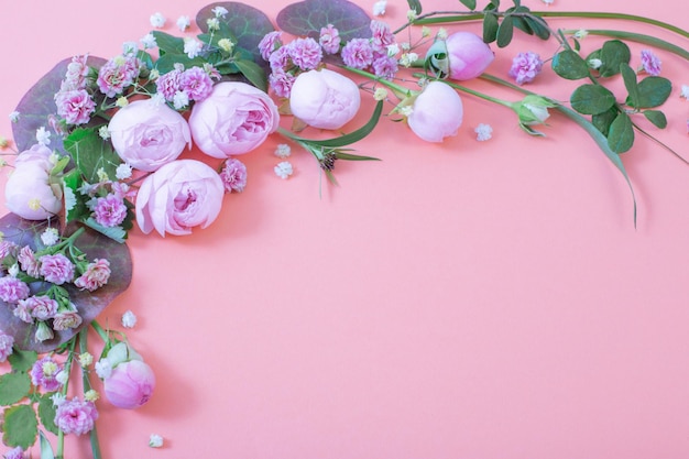 Pink roses with leaves on paper background