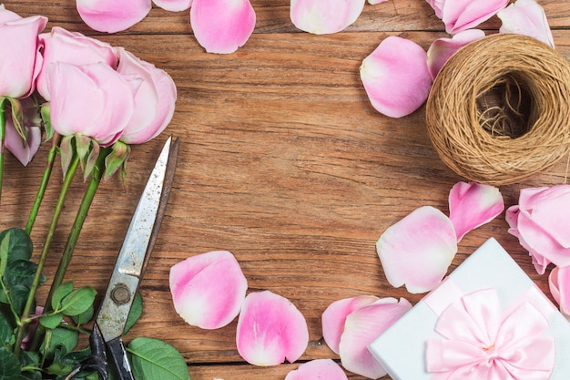 Pink roses on wooden background