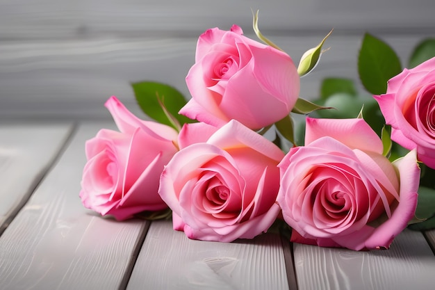 Pink roses on a wooden background