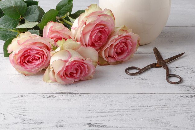 Pink roses on the wooden table