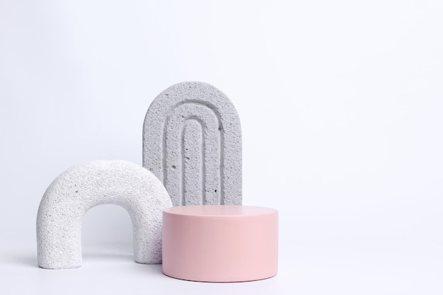 pink round podium with white gray geometric forms isolated on white background with copy space