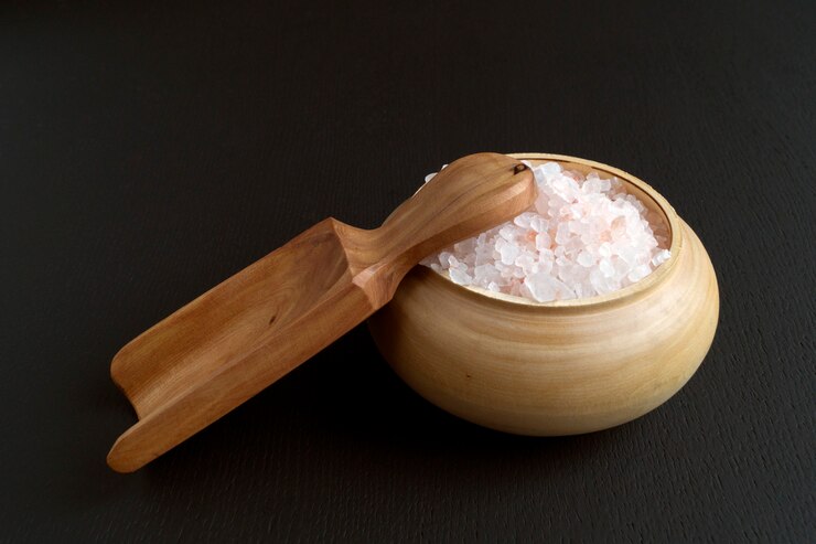 Pink salt in wooden bowl.