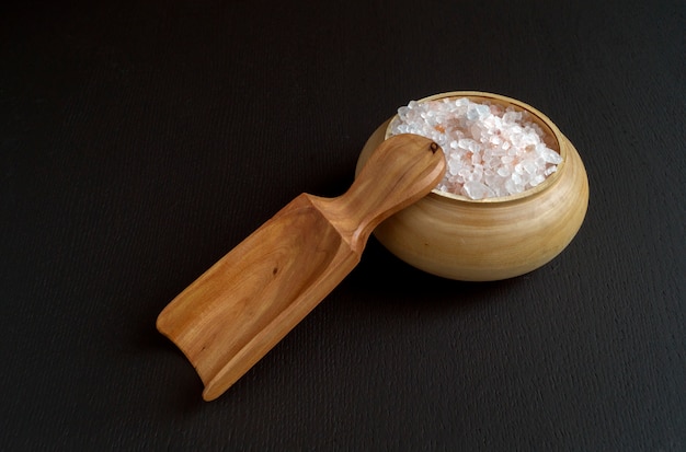 Pink salt in wooden bowl.