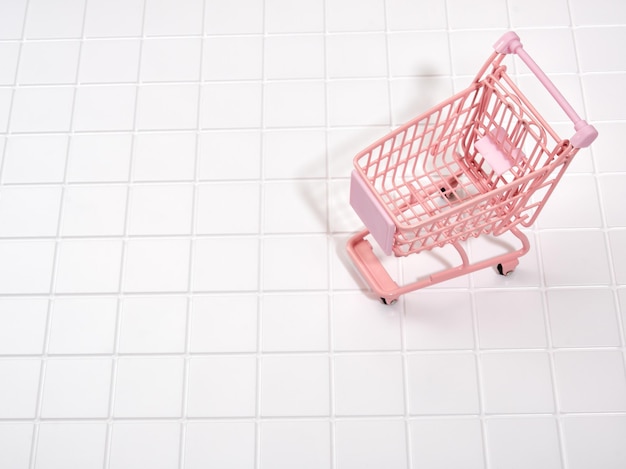 Pink shopping cart Idea of weekend shopping Copy space for text