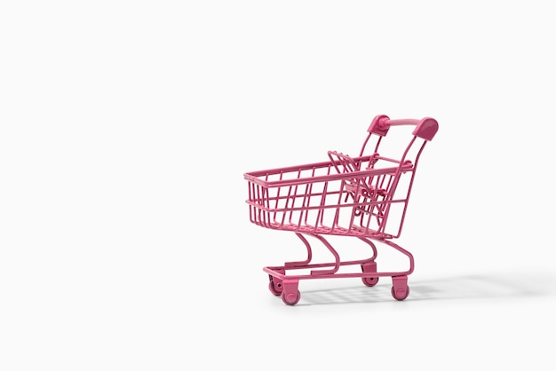 Pink shopping cart on white background