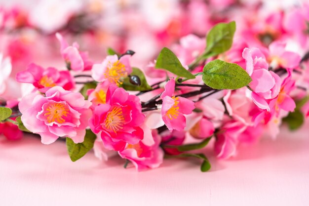 Pink silk flowers on a pink background.