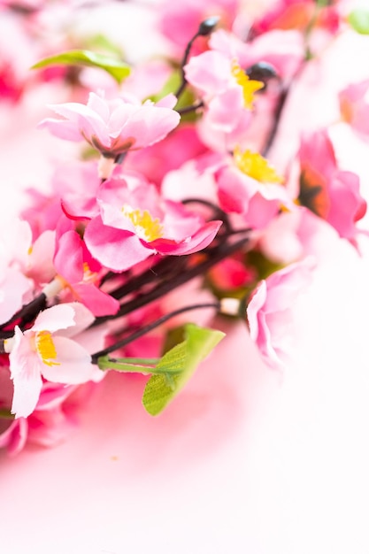 Pink silk flowers on a pink background.