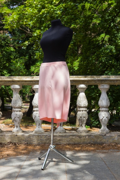 Pink skirt on mannequin Summer skirt with natural fabric Women's clothing on background of green trees