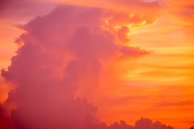 A pink sky with a cloud in the middle