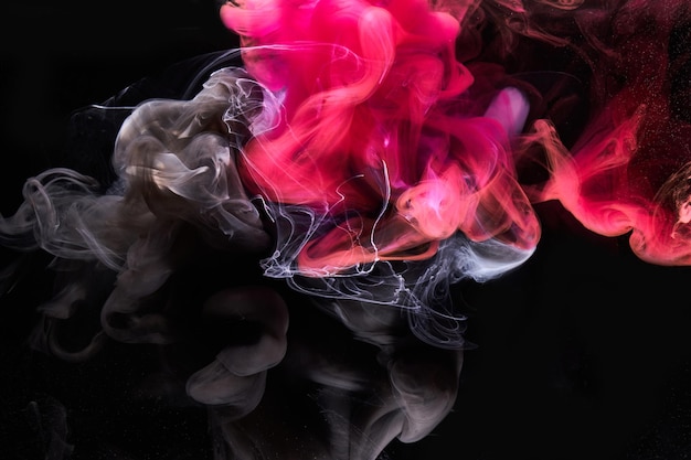 Pink smoke on black ink background, colorful fog, abstract swirling touch ocean sea, acrylic paint pigment underwater