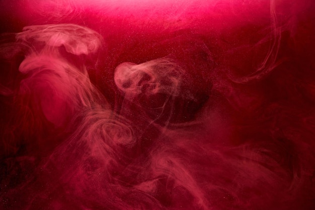 Pink smoke on black ink background, colorful fog, abstract swirling touch ocean sea, acrylic paint pigment underwater