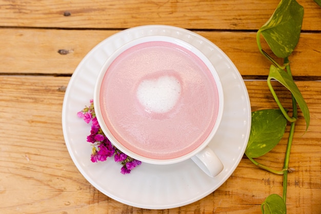 Foto frullato rosa in tazza bianca con cuore schiumato al centro