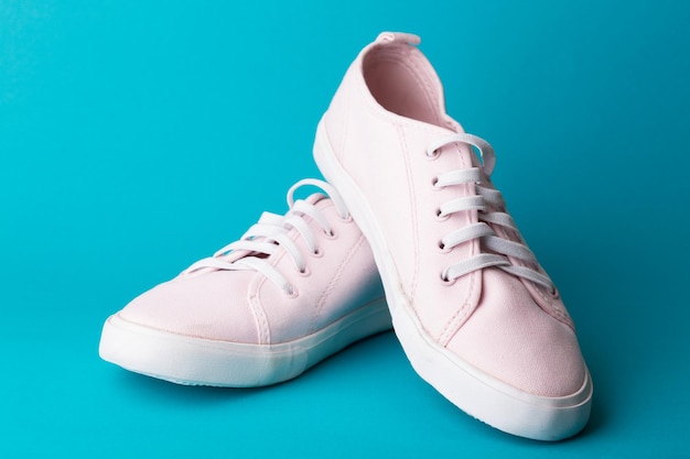 Pink sneakers on a blue background