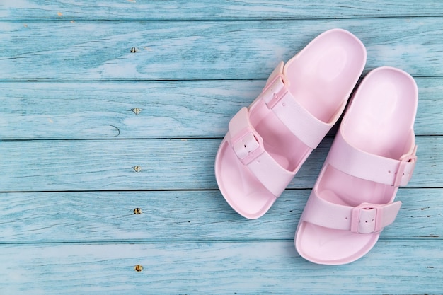 Photo pink sneakers stand on an isolated blue wooden background.