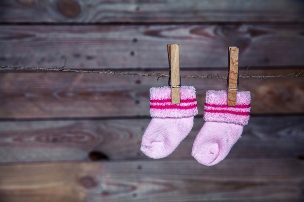 Pink socks hang on the clothespin wooden