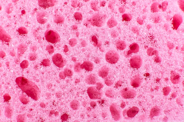 Pink sponge texture background. Close up, macro photo.