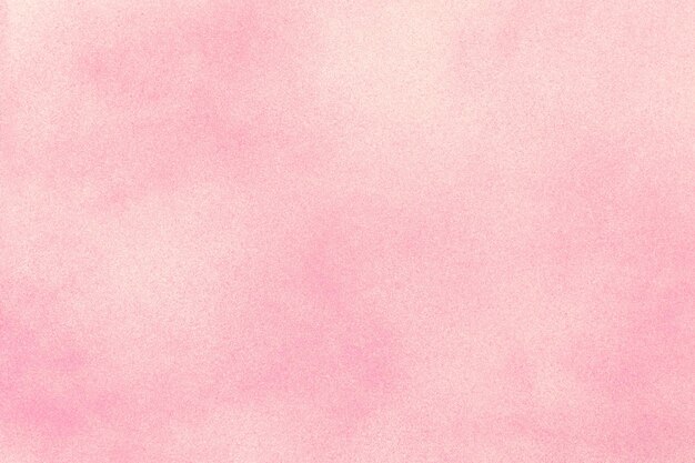 Pink spray paint on white paper background