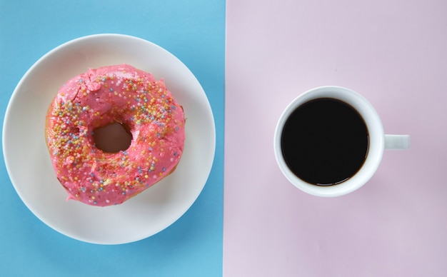 pink sprinkles donut and black coffee with copy space