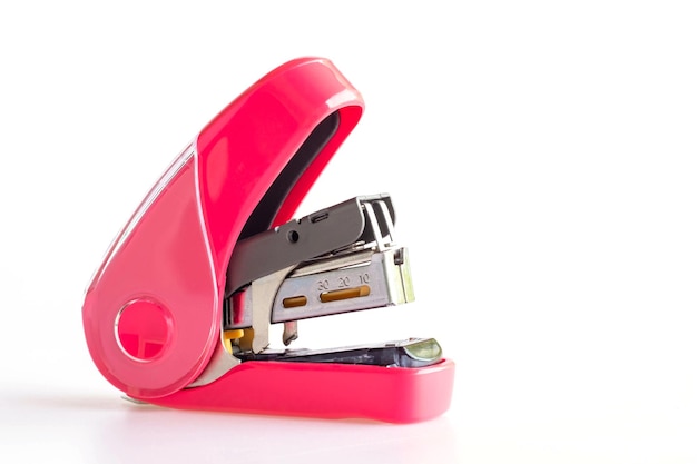 Pink stapler isolated on white background has a pressure relief system for comfortable use and does not hurt your hand macro