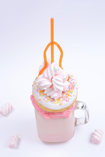 Pink strawberry freakshake with marshmallow and sweets