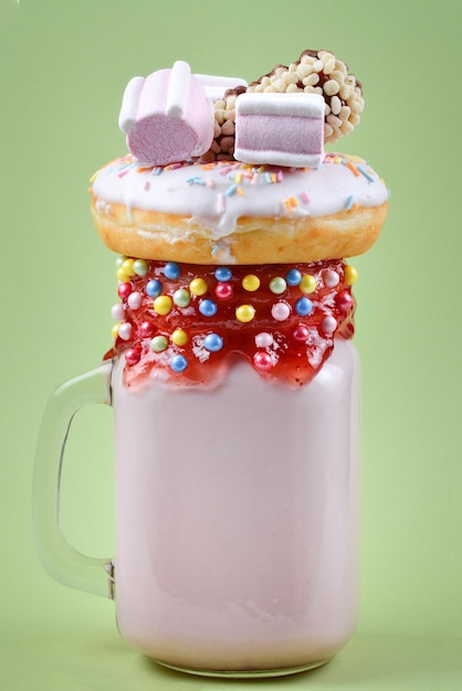 Pink strawberry freakshake with marshmallow and sweets