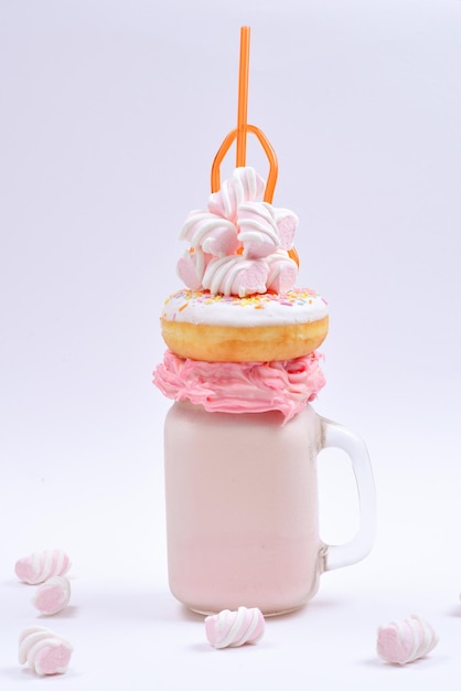 Pink strawberry freakshake with marshmallow and sweets