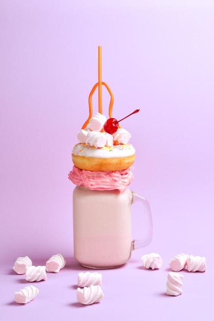 Pink strawberry freakshake with marshmallow and sweets