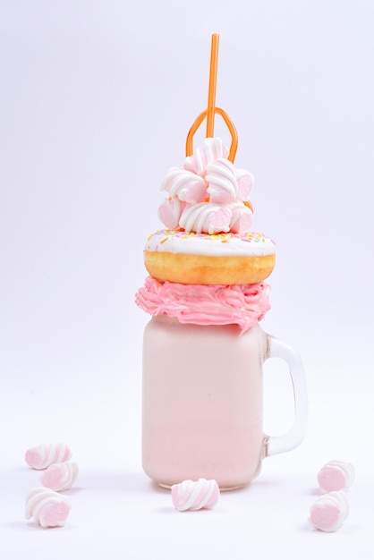 Pink strawberry freakshake with marshmallow and sweets