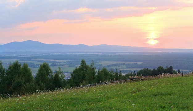 Pink sunset and countryside landscape