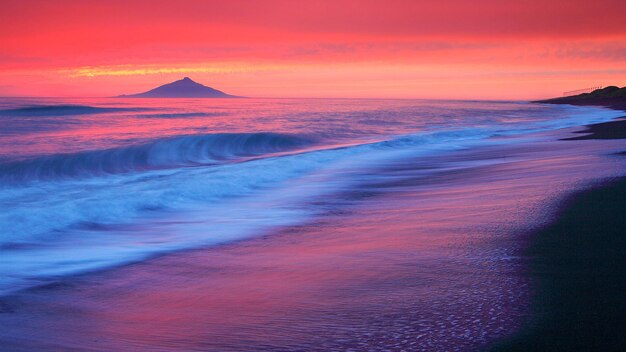 a pink sunset with a mountain in the background