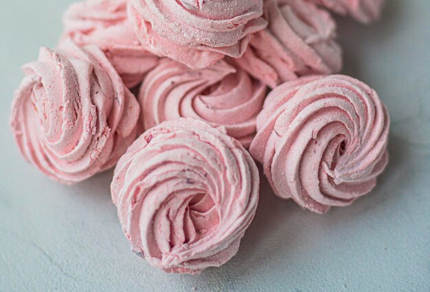 Pink sweet Meringue zephyr marshmallows on a light background