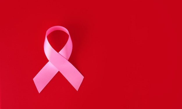 Pink symbol ribbon on a red surface