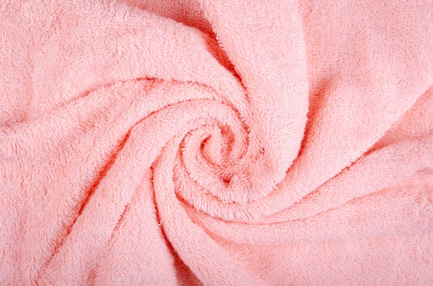 Pink towel fabric texture, top view photo.