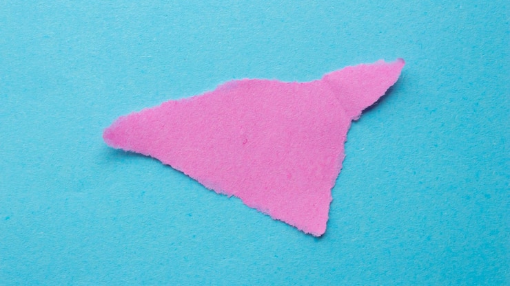 फोटो a pink triangle is cut into a triangle with a triangle cut out of it.