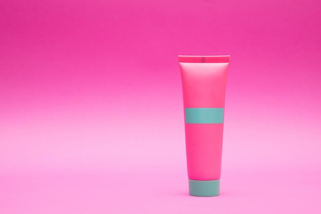 Photo pink tube of cream on a pink background