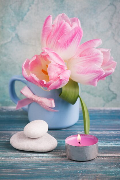 Pink tulip flowers in blue mug