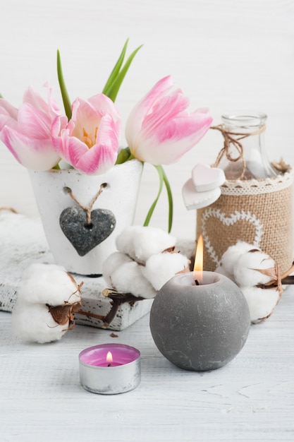 Pink tulip flowers, lit candles