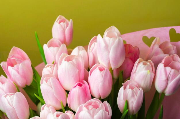 Pink tulips bouquet with hearts